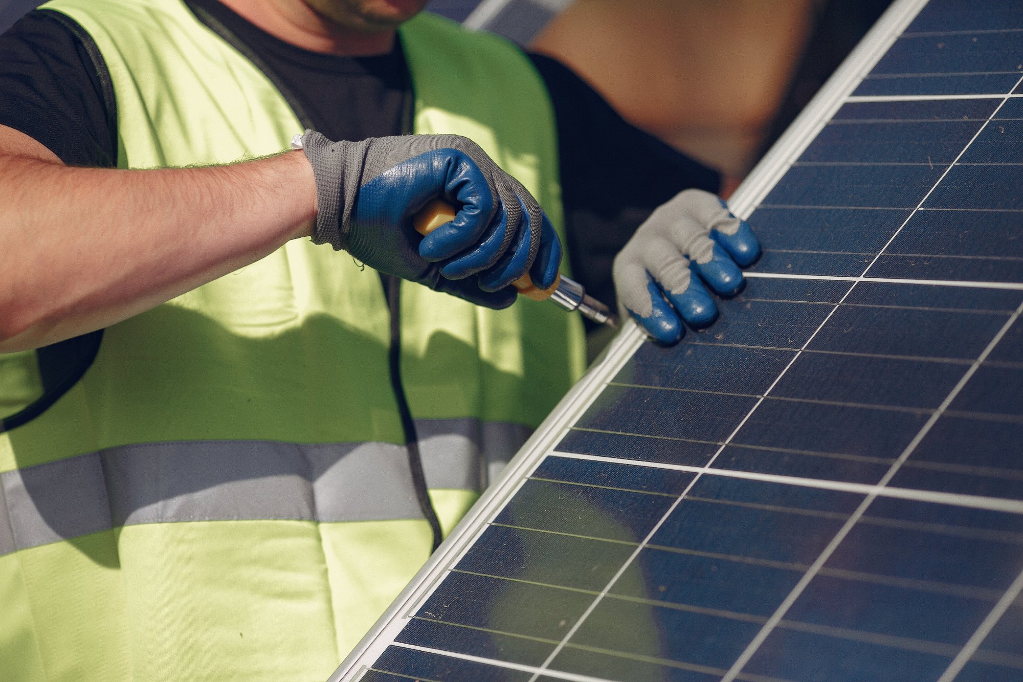 man-with-white-helmet-near-solar-panel.jpg
